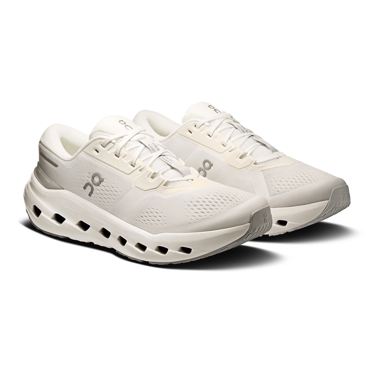 A pair of white athletic running shoes with a mesh upper, cushioned soles, and distinctive cutout details along the midsole, displayed on a white background.