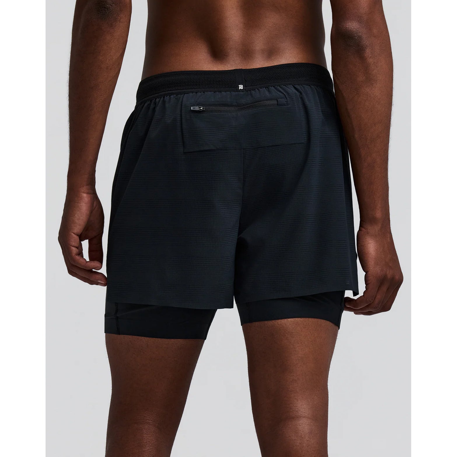 Men's Bandit CoolGrid 2-in-1 Run Short Black back view on male runner showing reflective centre back branding with CoolGrid breathable construction and moisture-wicking liner