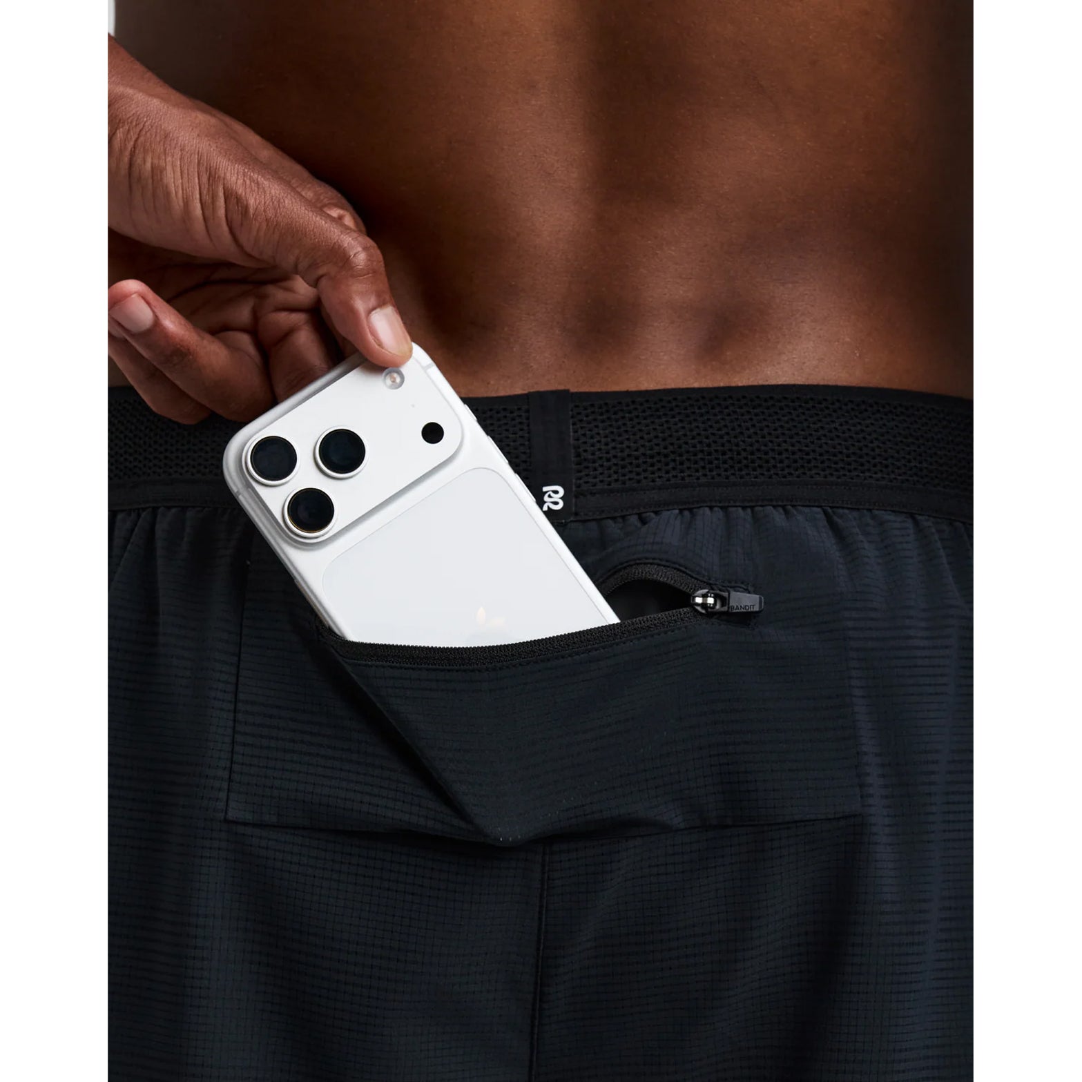 Men's Bandit CoolGrid 2-in-1 Run Short Black close-up of waterproof side leg phone pocket showing secure hidden storage with zero-bulk design for running essentials without bounce