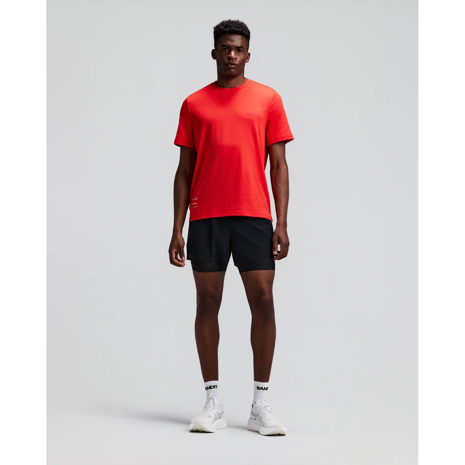 Men's Bandit CoolGrid 2-in-1 Run Short Black front full body view on male runner showing 2-in-1 CoolGrid outer with moisture-wicking liner and six-pocket system for road running and racing