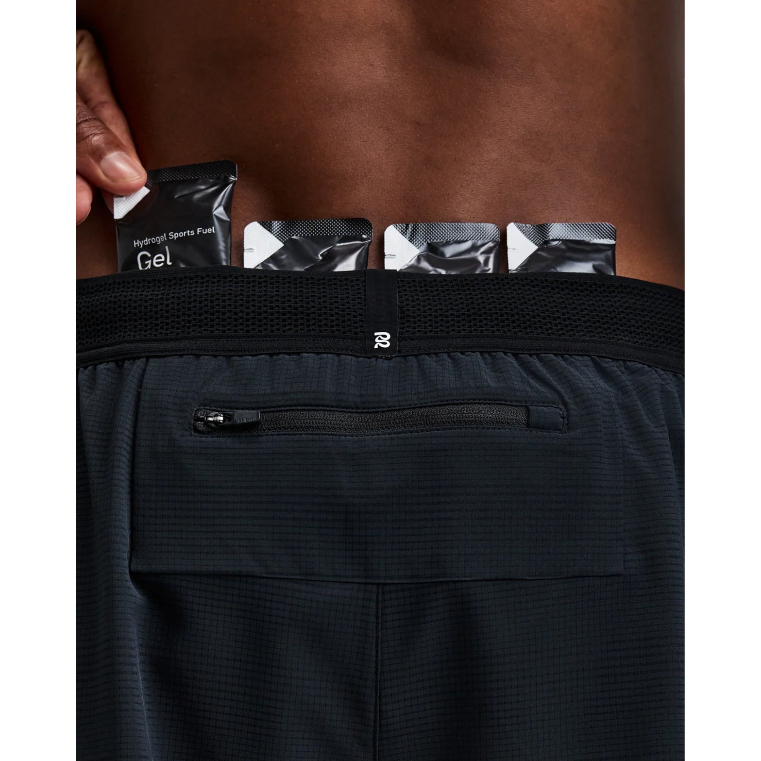 Men's Bandit CoolGrid 2-in-1 Run Short Black close-up of pocket system showing waterproof phone pocket on leg with four gel pockets and zero-bulk design for running essentials