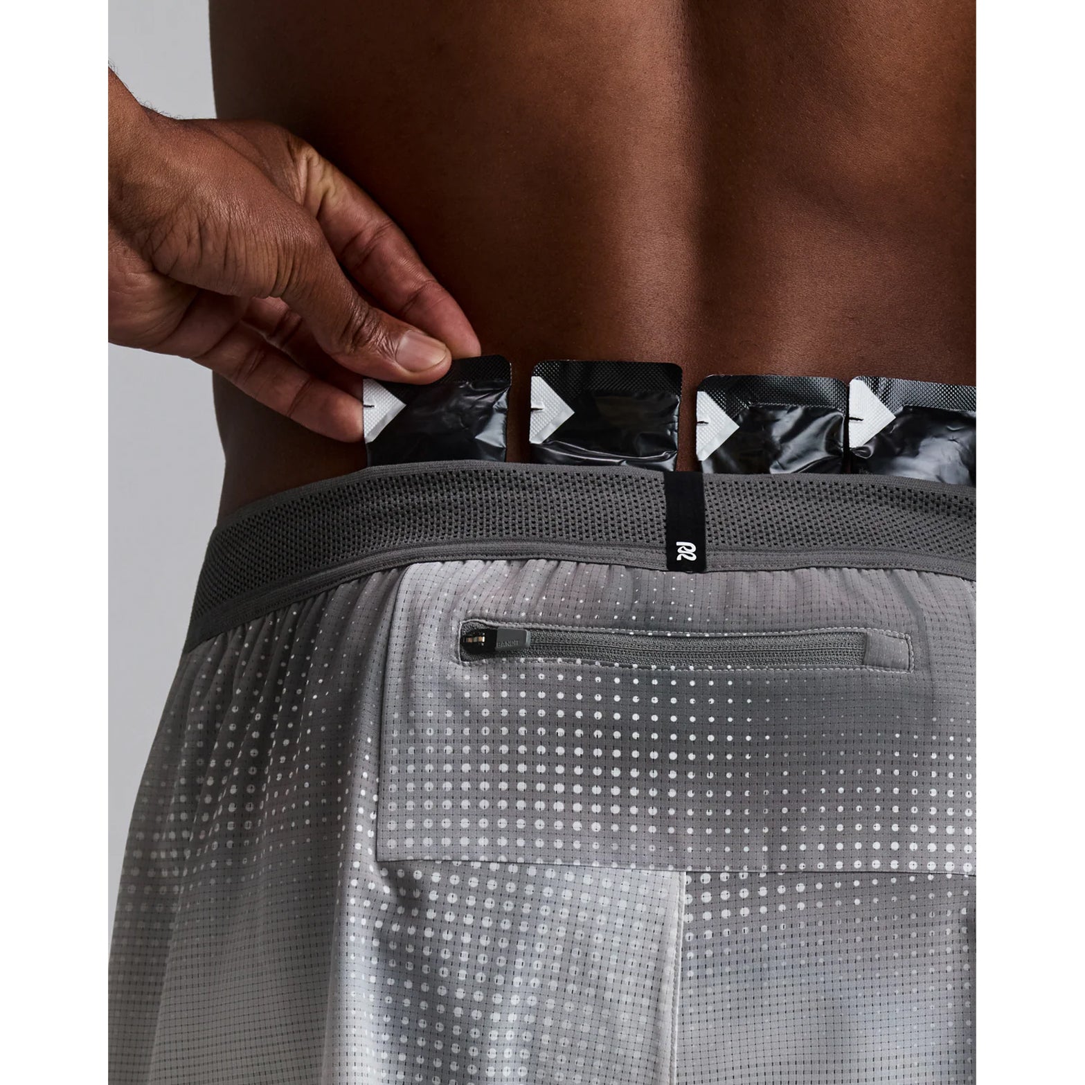 Men's Bandit CoolGrid 2-in-1 Run Short Micro Geo Gradient Slate Plaster close-up of pocket system showing waterproof phone pocket on leg with four gel pockets and zero-bulk design for running essentials