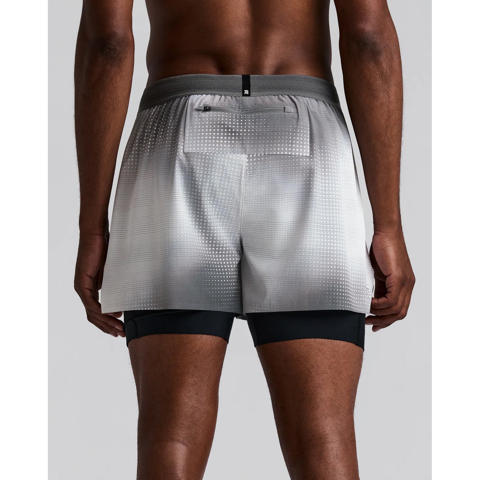 Men's Bandit CoolGrid 2-in-1 Run Short Micro Geo Gradient Slate Plaster back view on male runner showing reflective centre back branding with Micro Geo Gradient CoolGrid construction and moisture-wicking liner