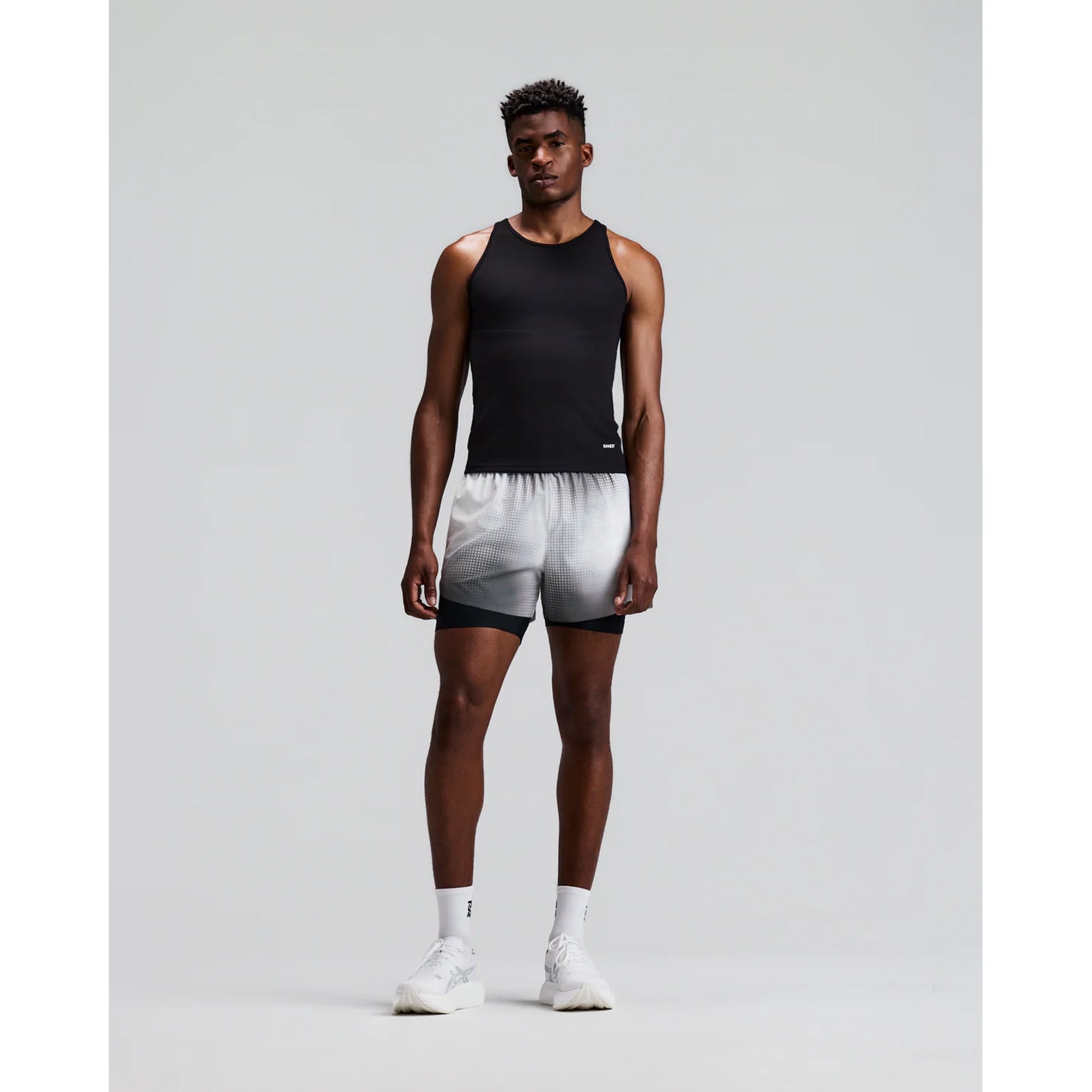 Men's Bandit CoolGrid 2-in-1 Run Short Micro Geo Gradient Slate Plaster front full body view on male runner showing 2-in-1 Micro Geo Gradient CoolGrid outer with moisture-wicking liner and six-pocket system for road running and racing
