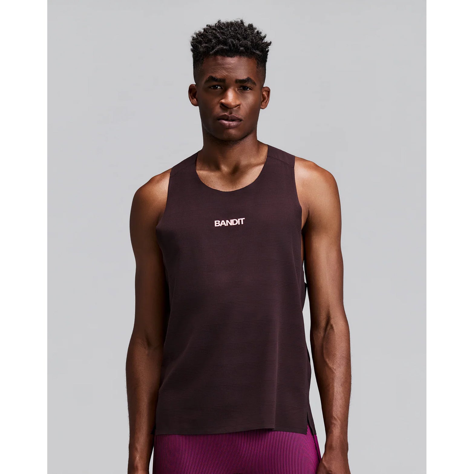 Men's Bandit CoolGrid Training Singlet with Flopack Espresso front view on male runner showing CoolGrid breathable fabric with high neckline and two-tone reflective graphics for training performance