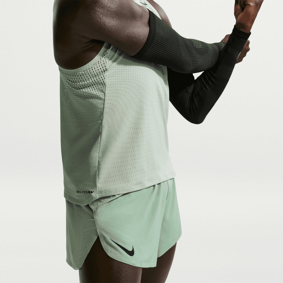 Men's Nike Dri-FIT AeroSwift ADV 2 Inch Running Shorts Steam Black side view on male runner showing 2-inch inseam with four-way stretch woven fabric, Flyvent breathable waistband and lightweight racing construction for competitive performance