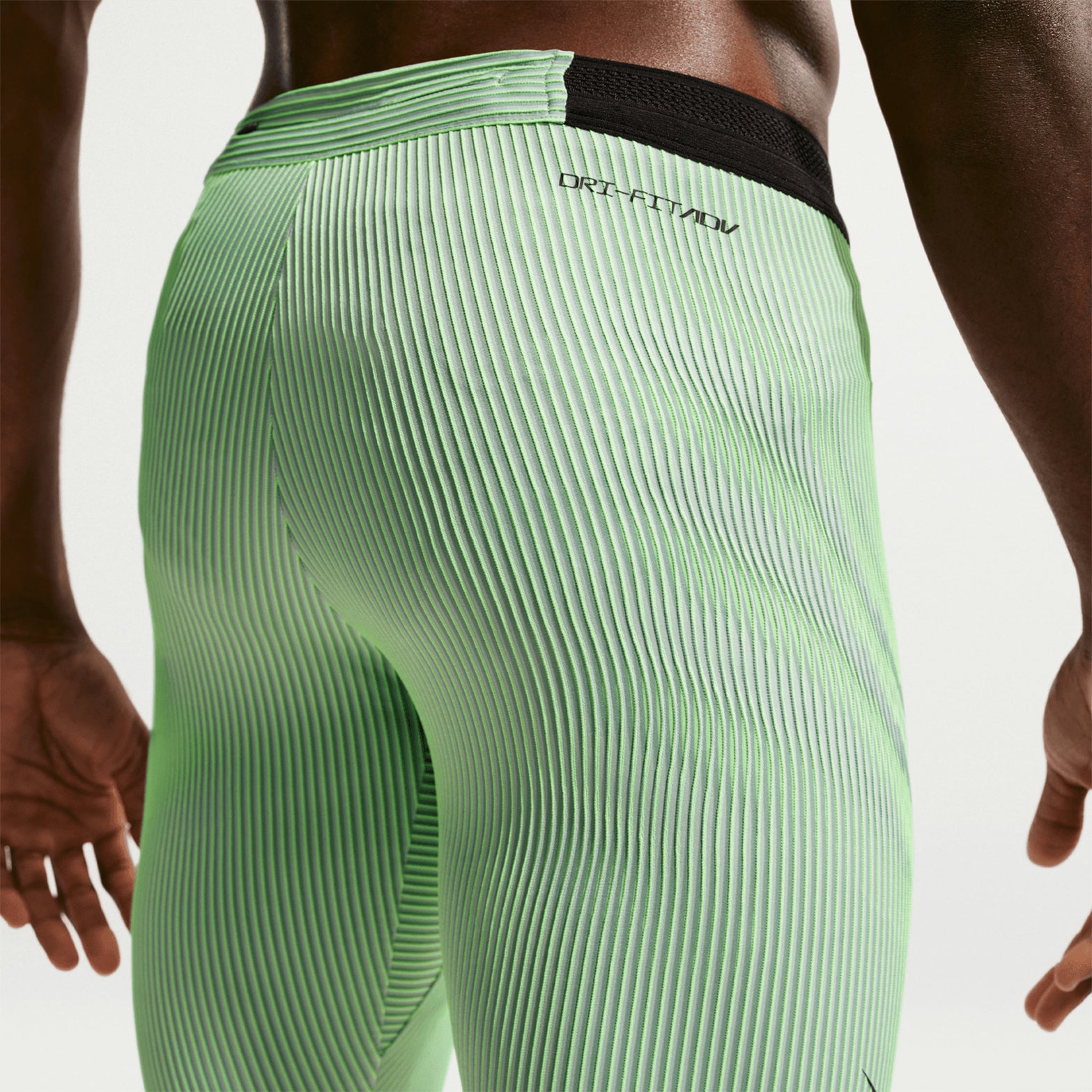 Men's Nike Dri-FIT AeroSwift ADV Half Tights Green close-up back showing center-back zippered phone pocket and moisture-wicking construction