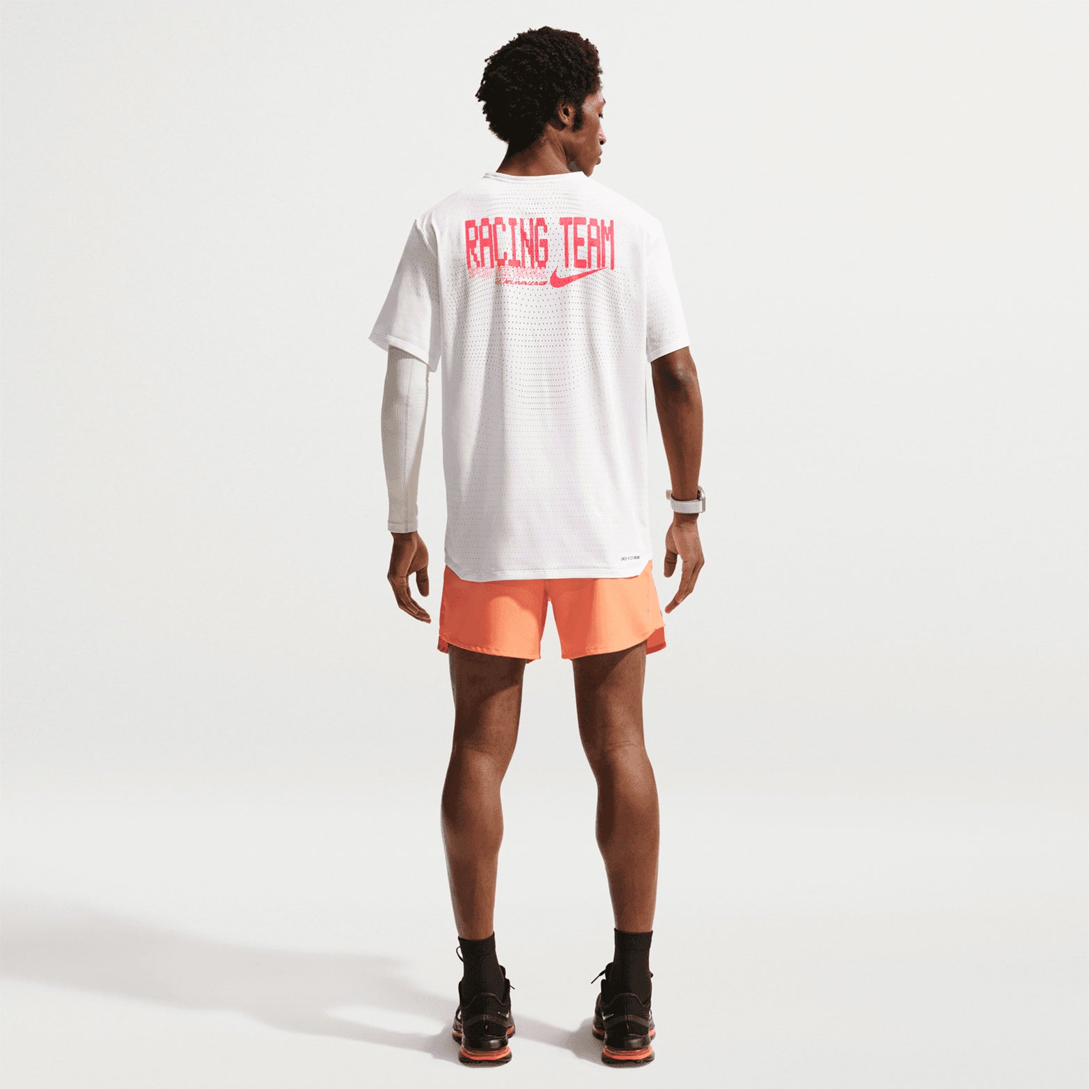 Nike AeroSwift men's Dri-FIT ADV running tee in Summit White — full body back view worn on model showing summit white bonded seams at shoulder, ultrabreathable knit fabric and non-reflective Swoosh logo