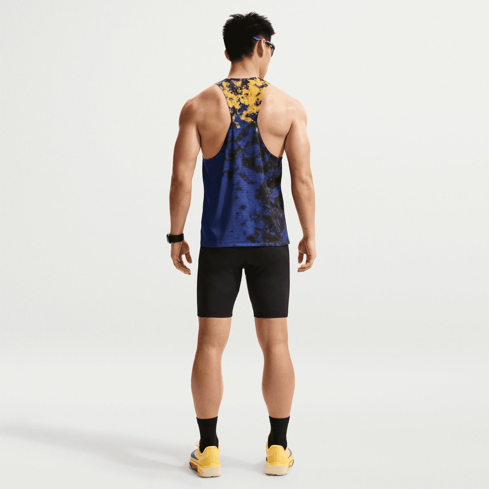 Men's Nike Dri-FIT AeroSwift ADV Running Vest Citron Pulse Lapis Bright Crimson back full body view on male runner showing breathable racing vest with moisture management for comfortable competitive running
