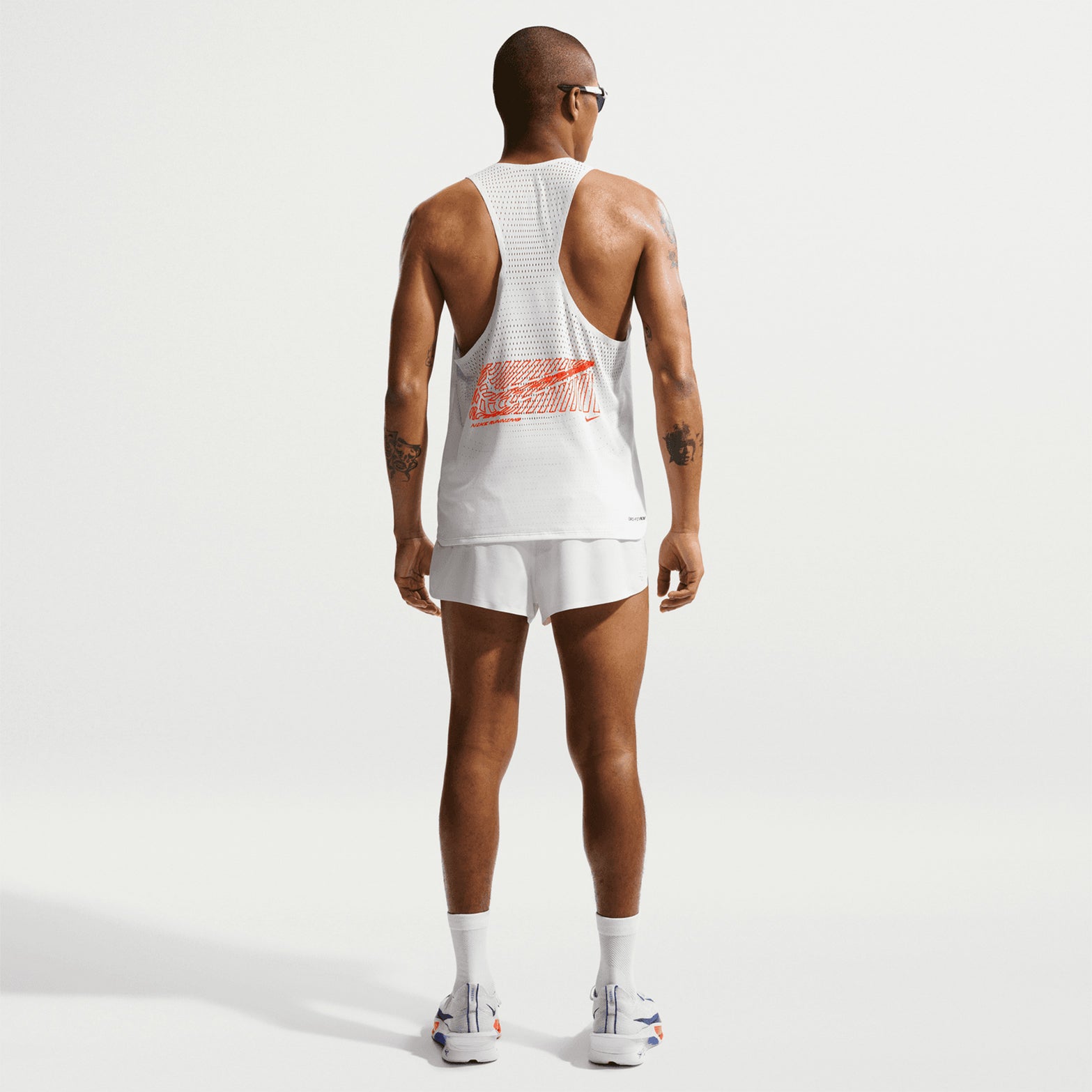 Nike AeroSwift men's Dri-FIT ADV running singlet in Summit White — full body back view worn on model showing summit white bonded seams at armhole, lower hem coverage and open-hole targeted airflow design
