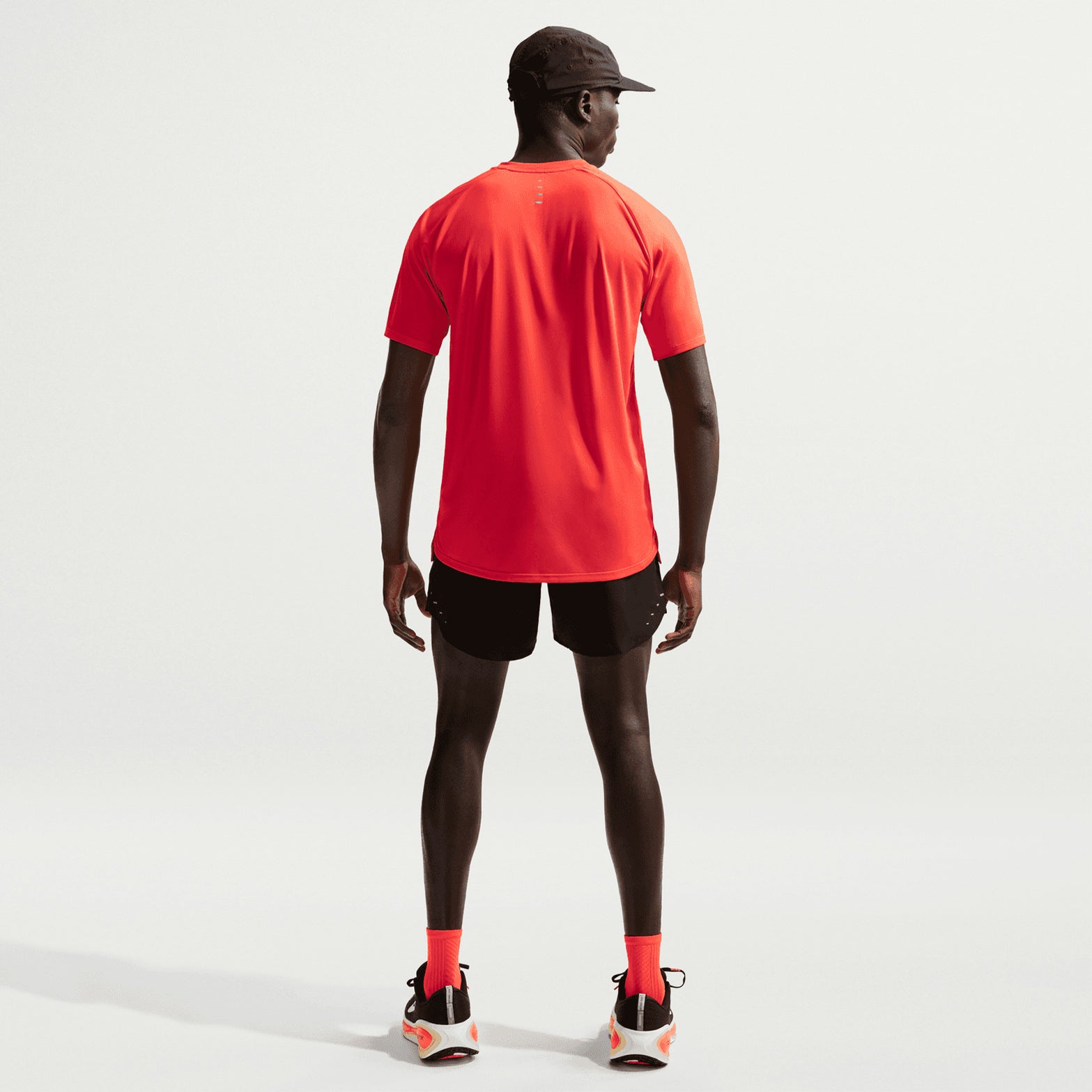 Men's Nike Dri-FIT Stride 5 Inch Shorts Black full body back view on male runner showing zippered phone pocket, breathable panel and ergonomic brief liner coverage