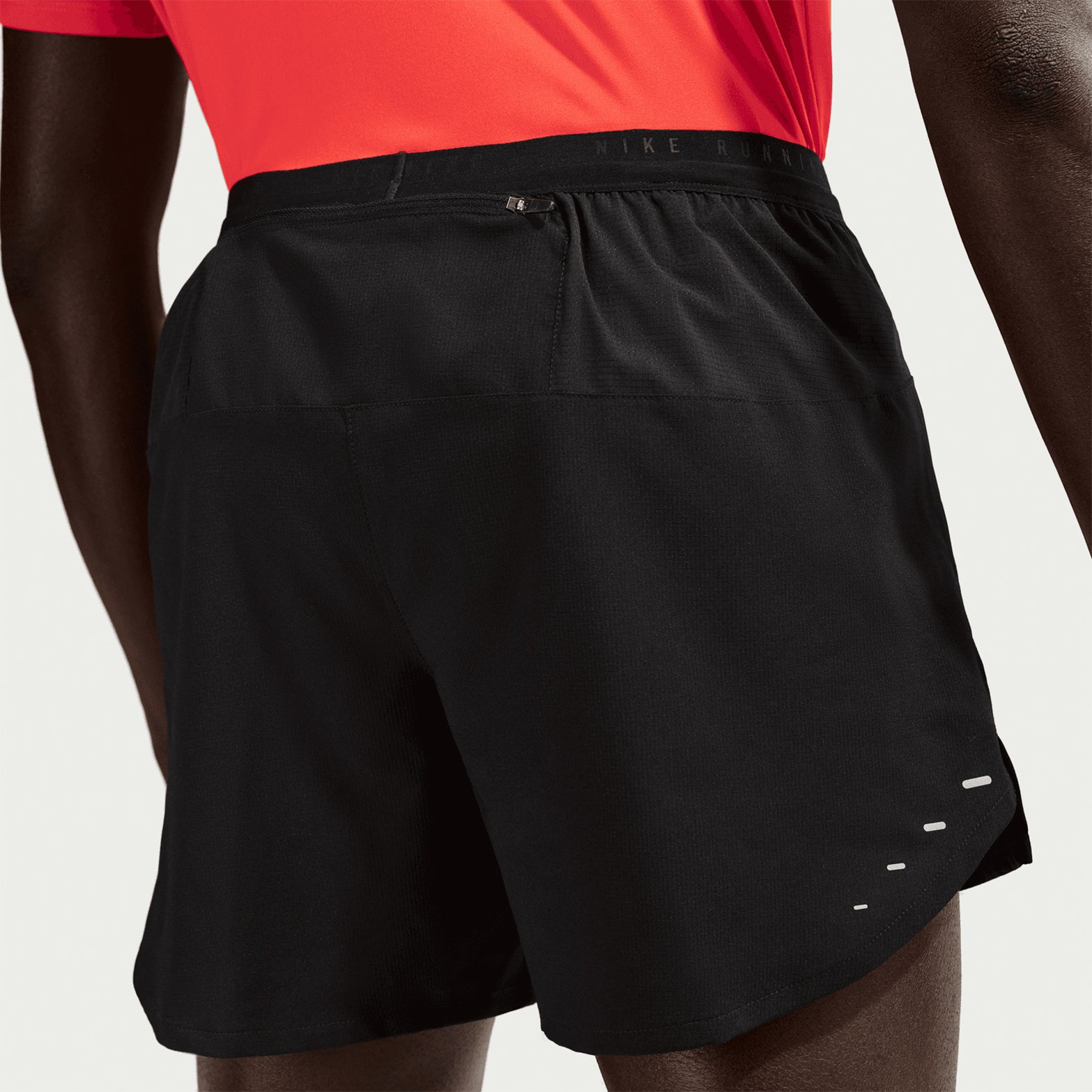 Men's Nike Dri-FIT Stride 5 Inch Shorts Black close-up back showing breathable upper back panel and zippered phone pocket with internal moisture barrier