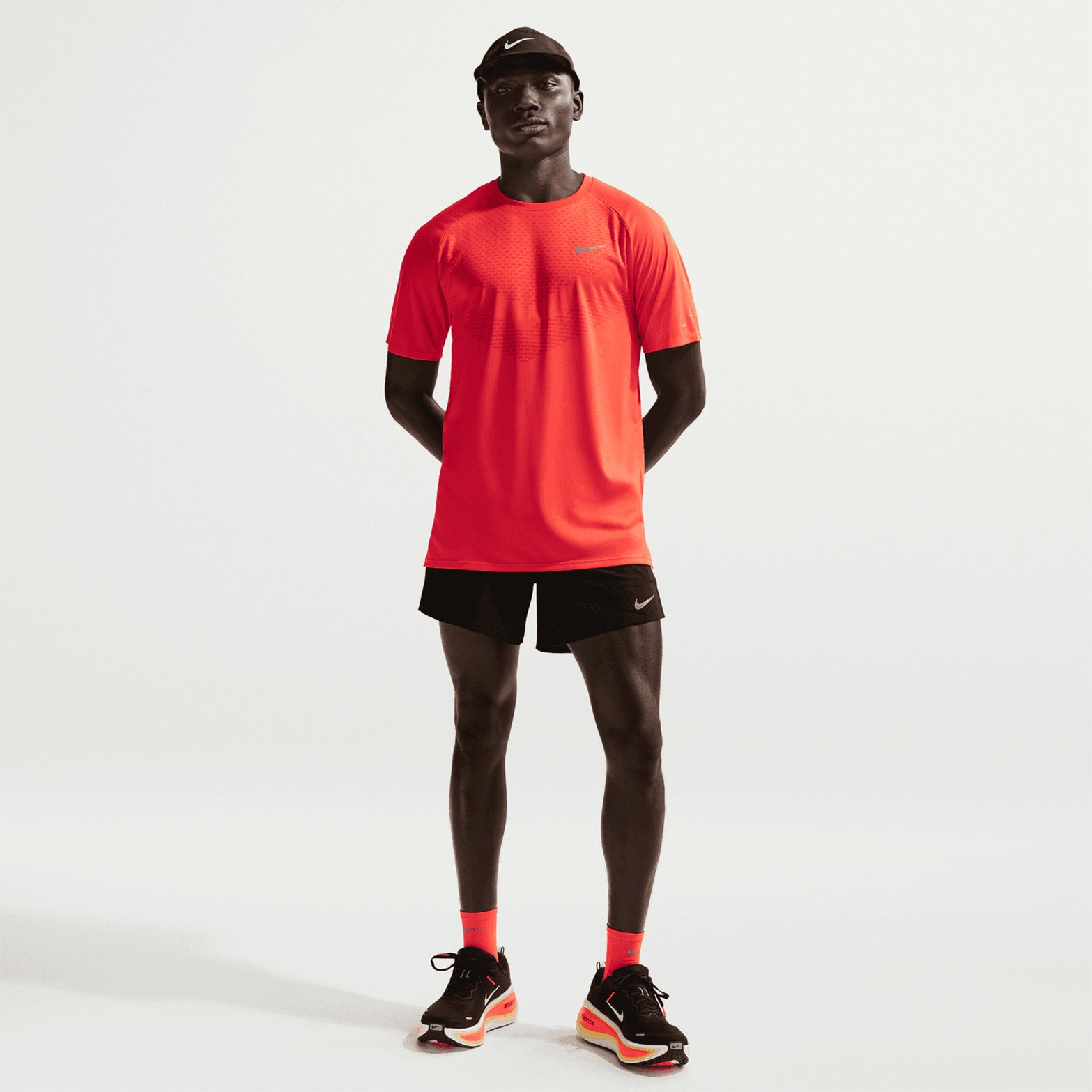 Men's Nike Dri-FIT Stride 5 Inch Shorts Black full body front view on male runner showing standard fit, side pockets and lightweight breathable construction
