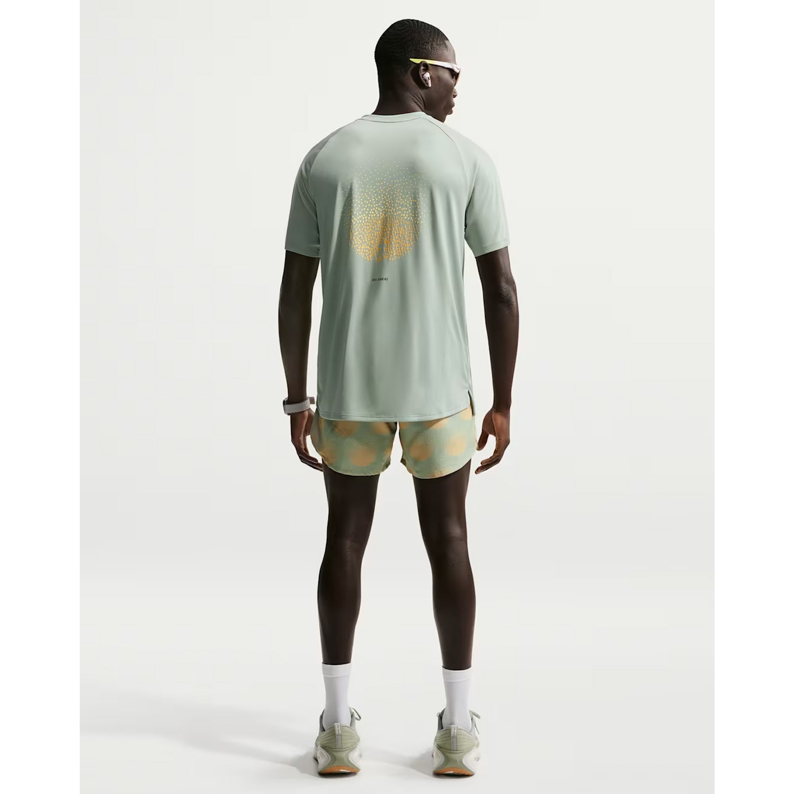 Nike Stride men's Dri-FIT 5 inch shorts in Jade Horizon — full body back view worn on model showing jade horizon breathable upper back panel, zippered phone pocket with moisture protection and standard fit relaxed silhouette