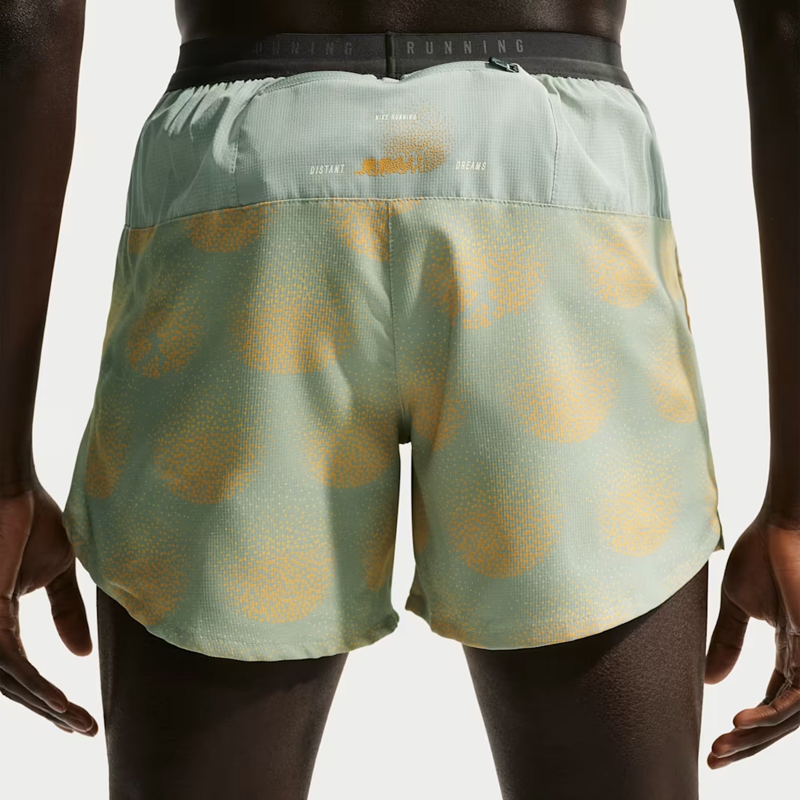 Nike Stride men's Dri-FIT 5 inch shorts in Jade Horizon — back view worn on model showing jade horizon breathable upper back panel, zippered back phone pocket with internal moisture barrier and ergonomic brief liner