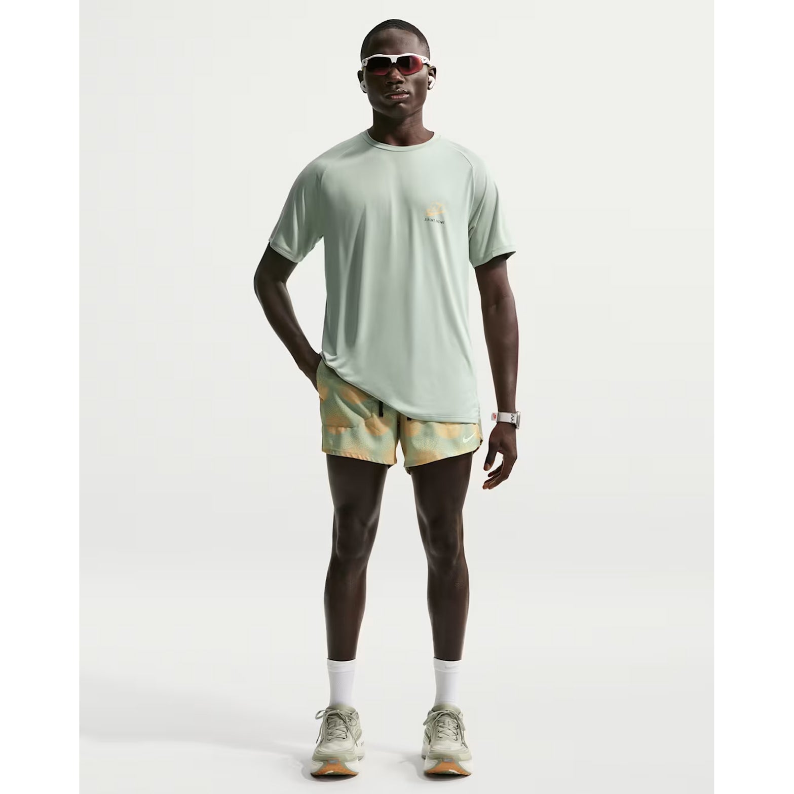 Nike Stride men's Dri-FIT 5 inch shorts in Jade Horizon — full body front view worn on model showing jade horizon 5 inch inseam, unrestricted leg movement design, narrow waistband with drawcord and side pocket storage