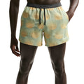 Nike Stride men's Dri-FIT 5 inch shorts in Jade Horizon — front view worn on model showing jade horizon lightweight woven fabric with narrow waistband, side pockets and shallow rise construction