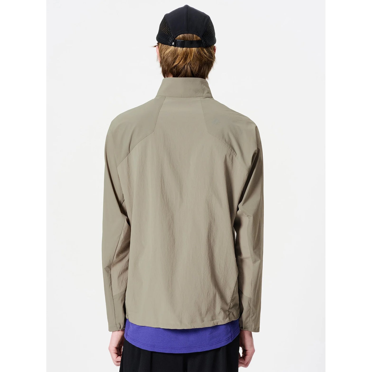 Goldwin Men's Eris Hybrid Jacket Arid Beige back view on male runner showing breathable mesh fabric in back section and adjustable drawstring hem