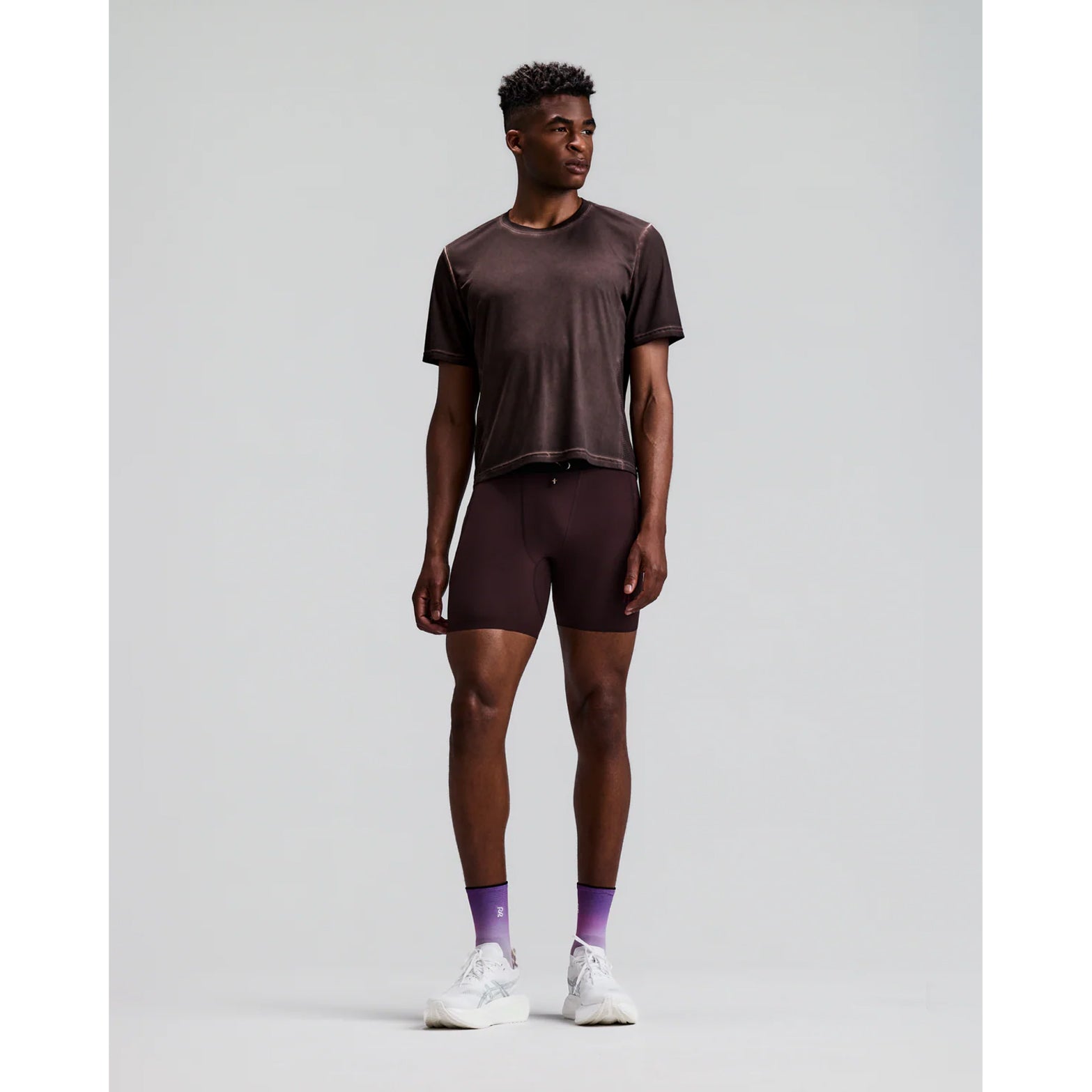 Men's Bandit FrioSoft Perforated Box Tee Espresso front full body view on male runner showing boxy silhouette with FrioSoft lightweight flowy fabric and SaltFade vintage technique for warm weather running and casual wear