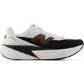 Men's New Balance FuelCell Rebel v5 Running Shoes White Neo Flame outer side view showing FuelCell PEBA and EVA foam blend with geometric midsole design for propulsive energetic daily training