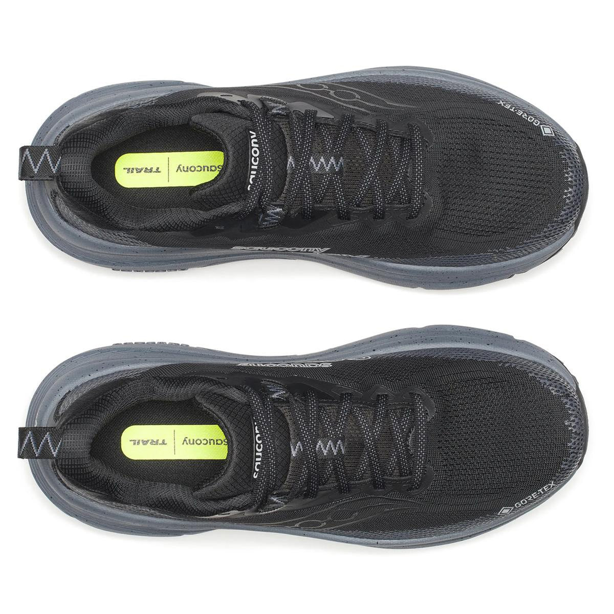 Top view of Saucony Men’s Guide TR GTX Black / Gunmetal running shoes with gray soles and yellow insoles reading TRAIL and DUOCOMY. Max cushion stability and GORE-TEX waterproofing; shoes placed side by side, facing upward.