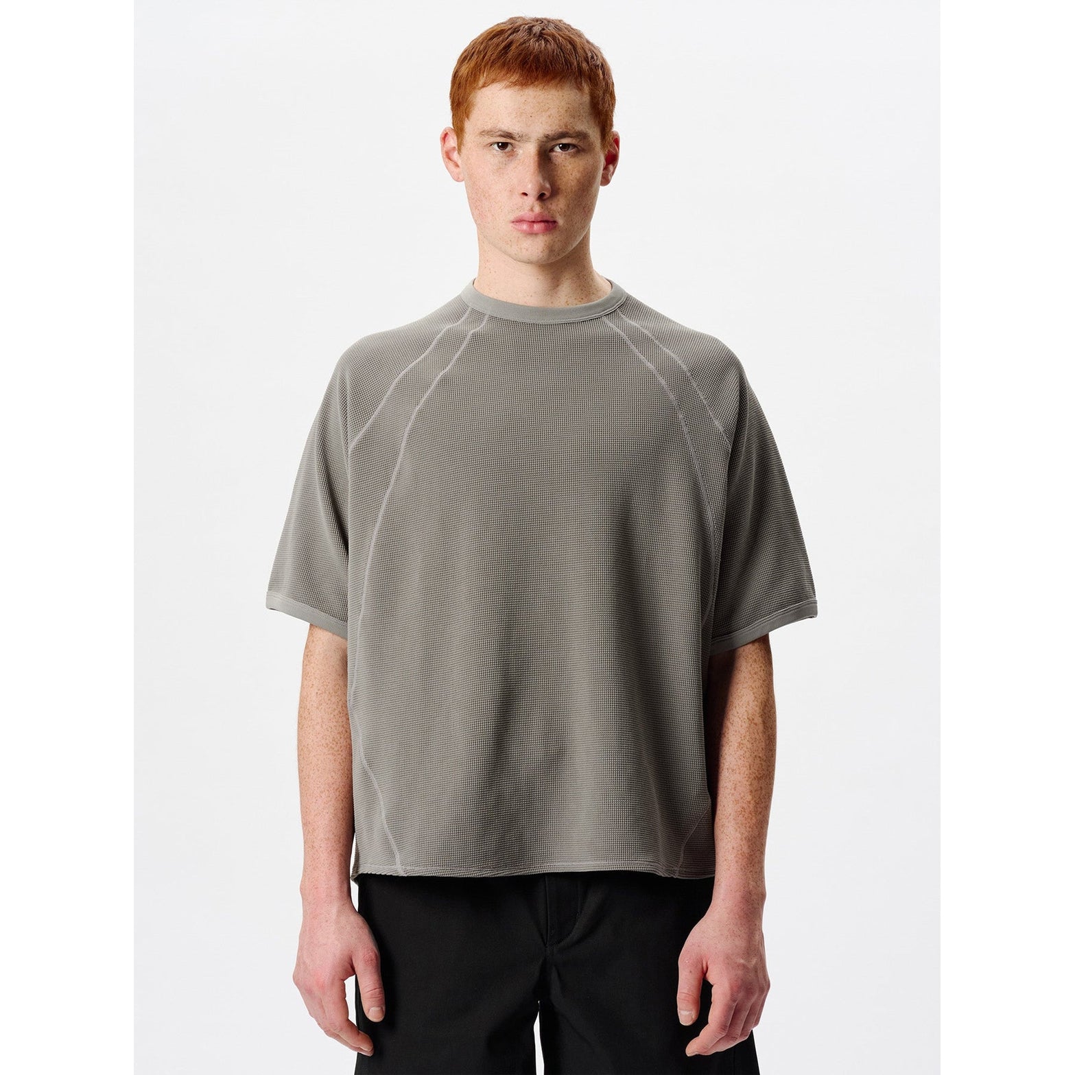 Goldwin Mesh WF Actinoid Tee men's in Arid Beige — front view worn on model showing relaxed fit, raglan sleeve stitching detail and arid beige waffle-knit mesh construction
