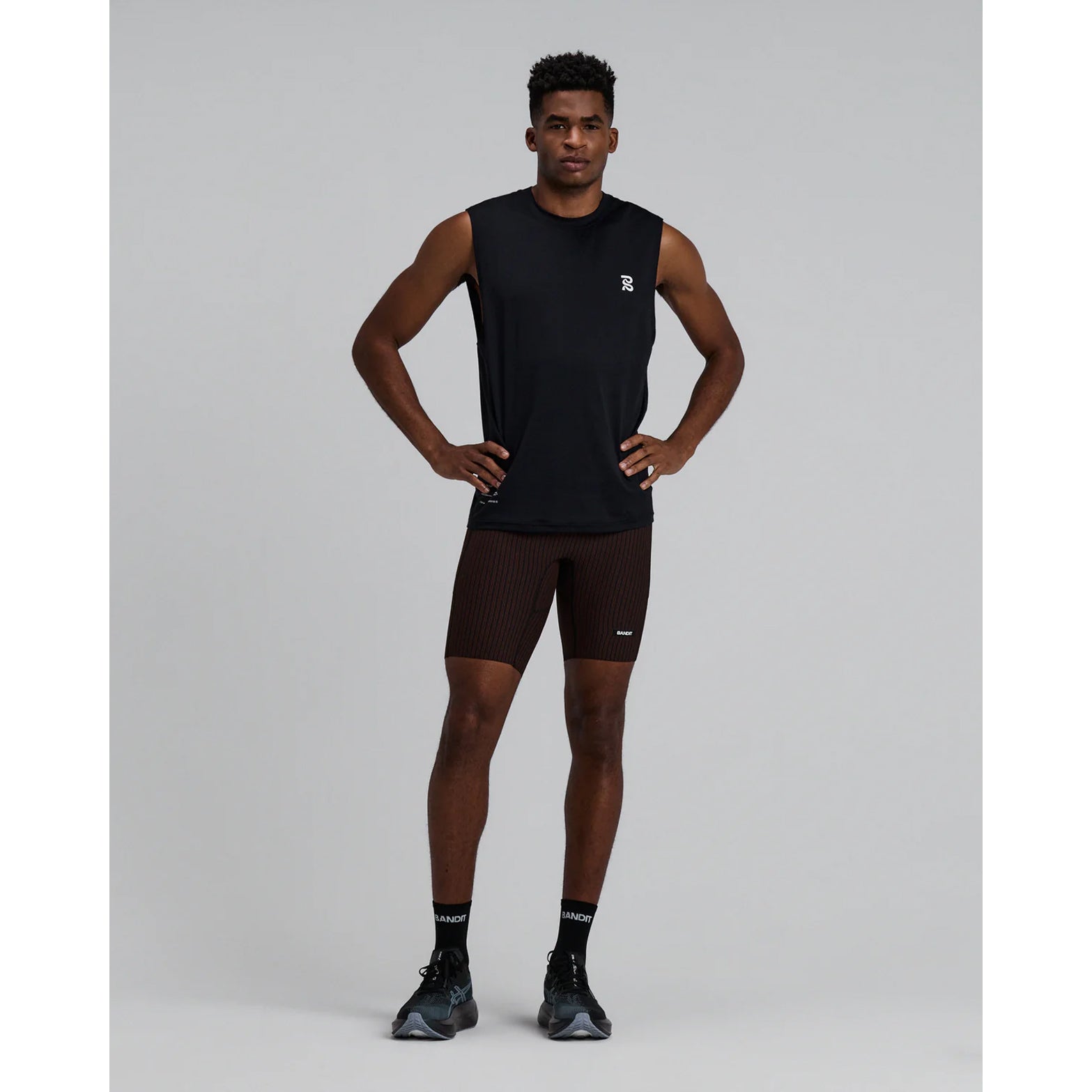 Men's Bandit Micromesh Run Tank Black front full body view on male runner showing relaxed tank fit with breathable Micromesh moisture-wicking for training and everyday running