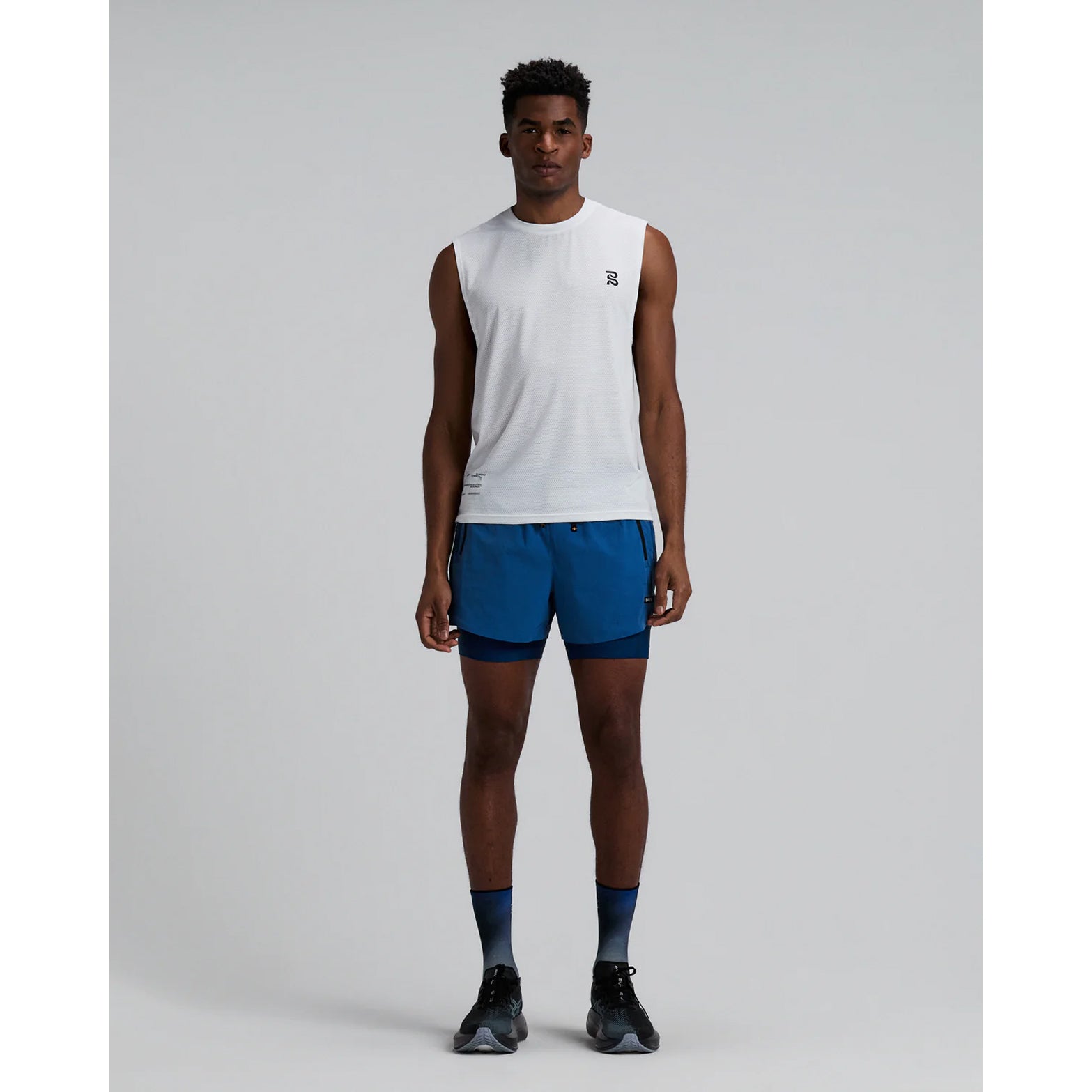 Men's Bandit Micromesh Run Tank White front full body view on male runner showing relaxed tank fit with breathable Micromesh moisture-wicking for training and everyday running