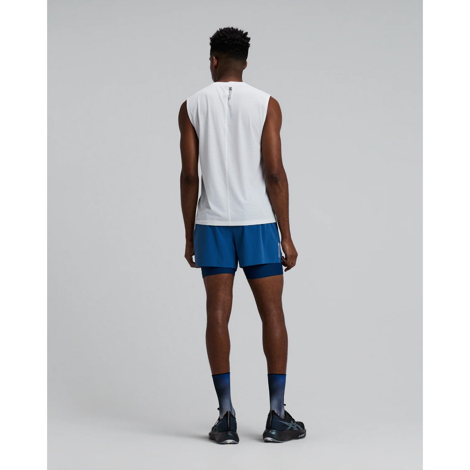 Men's Bandit Micromesh Run Tank White back full body view on male runner showing relaxed tank construction with fast-drying Micromesh fabric for comfortable running and training