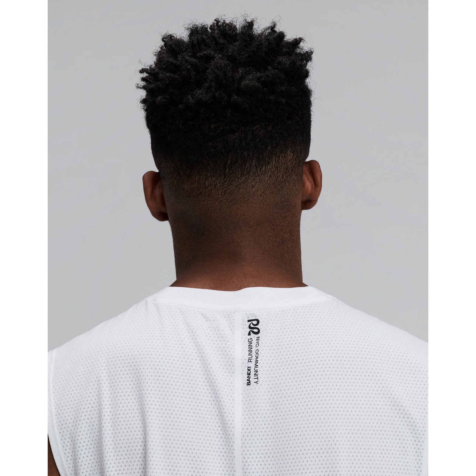 Men's Bandit Micromesh Run Tank White close-up of back showing fast-drying Micromesh fabric with sweat-wicking airflow construction for sustained running efforts