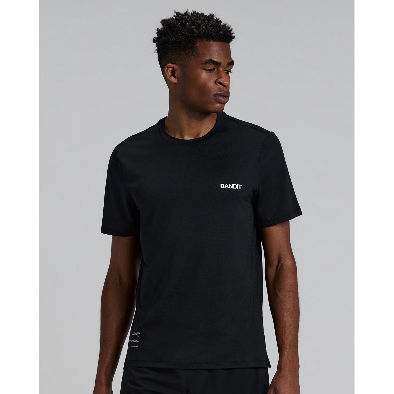 Men's Bandit Micromesh Run Tee Black front view showing relaxed silhouette with sweat-wicking Oeko-Tex Certified mesh and reflective graphic at centre front