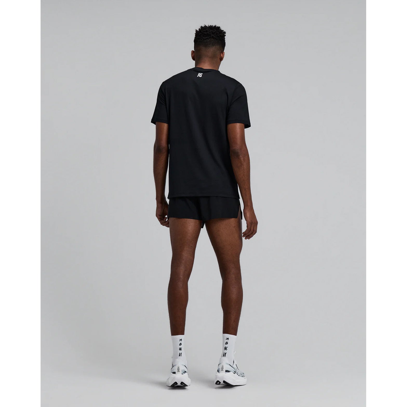 Men's Bandit Micromesh Run Tee Black full body back view on male runner showing breathable Micromesh fabric with dyed-to-match reflective graphic for visibility