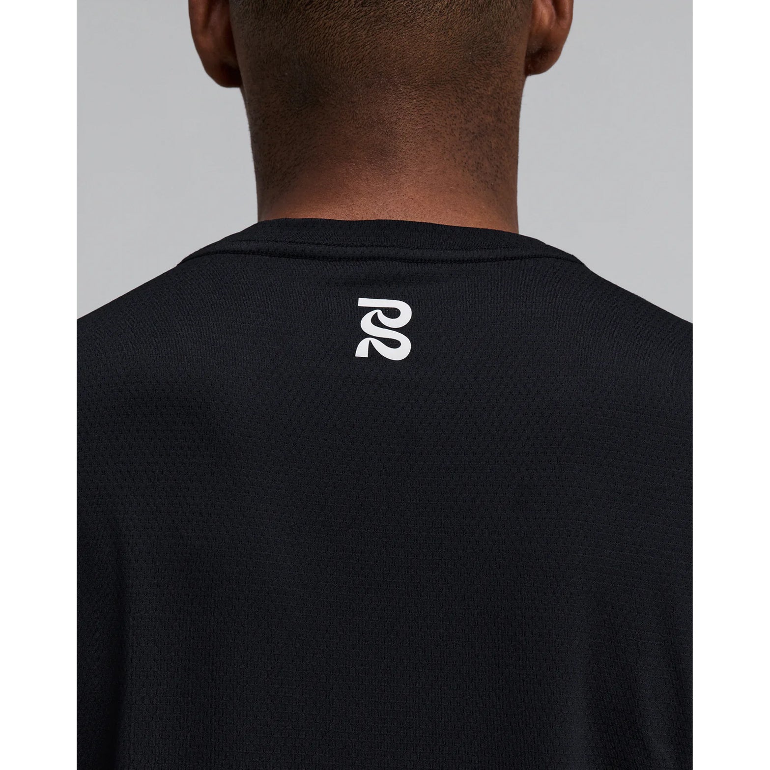 Men's Bandit Micromesh Run Tee Black close-up back showing logo detail on Oeko-Tex Certified BPA-free Micromesh fabric with reflective graphic