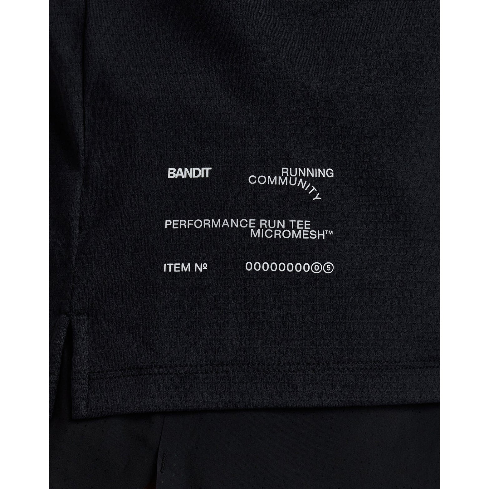 Men's Bandit Micromesh Run Tee Black close-up of reflective graphics at centre front and back plus reflective infographic at front hem for low-light running visibility