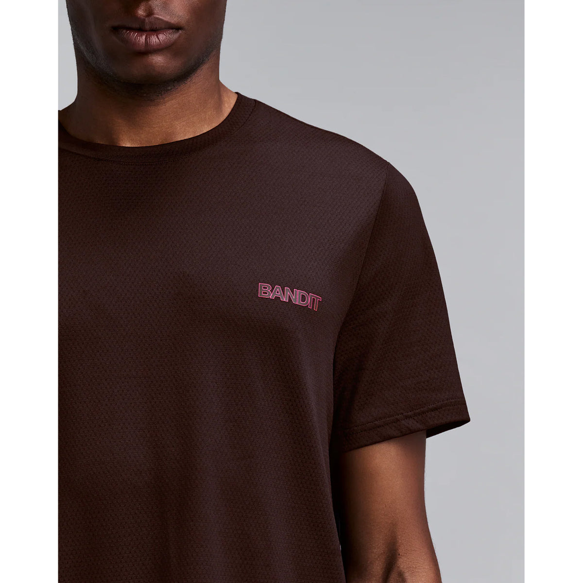Men's Bandit Micromesh Run Tee Espresso close-up of front showing subtle two-tone Bandit logo branding with ultra-breathable Micromesh fabric and Oeko-Tex certified BPA-free construction