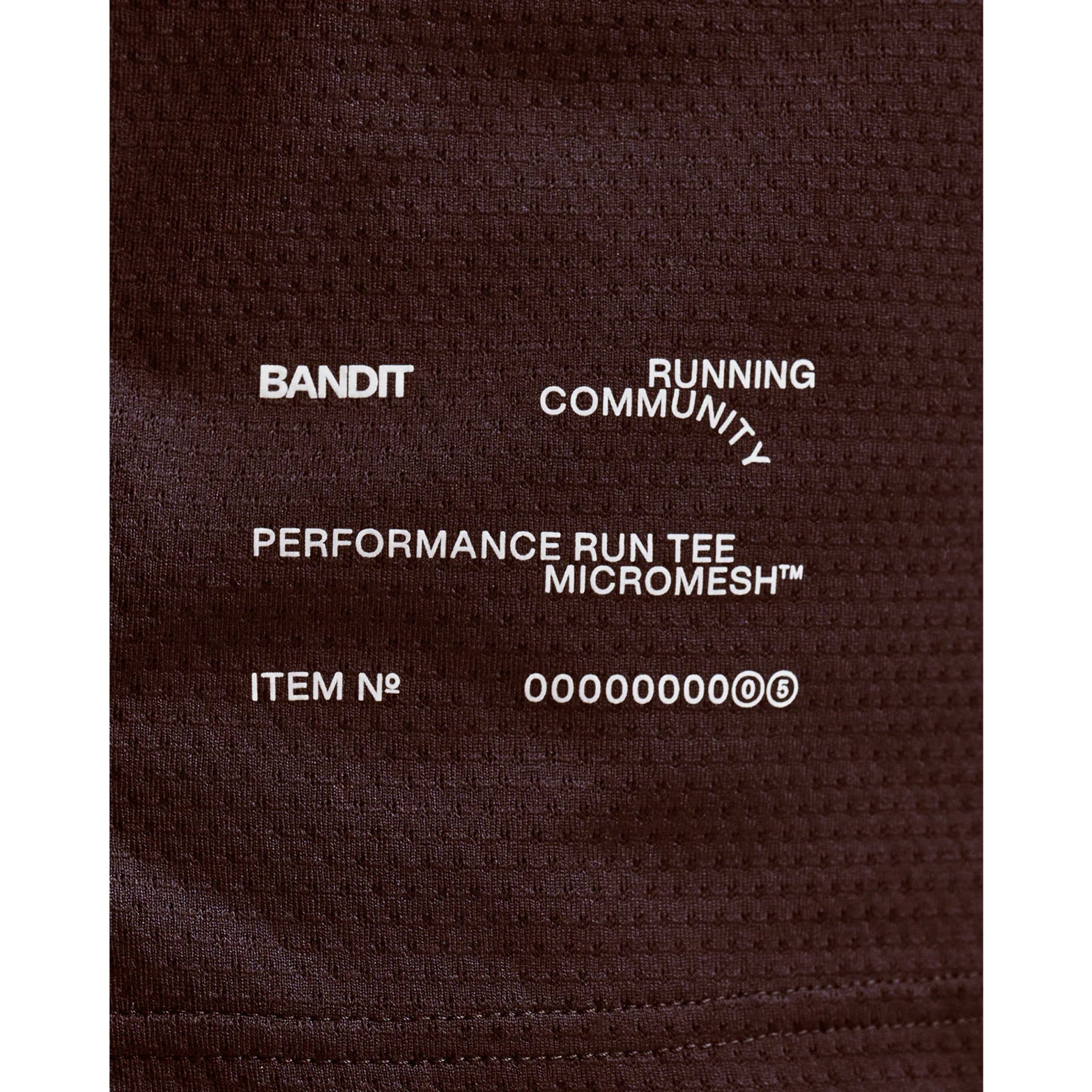 Men's Bandit Micromesh Run Tee Espresso close-up of hem showing subtle two-tone Bandit logo with reflective details for low-light visibility during running