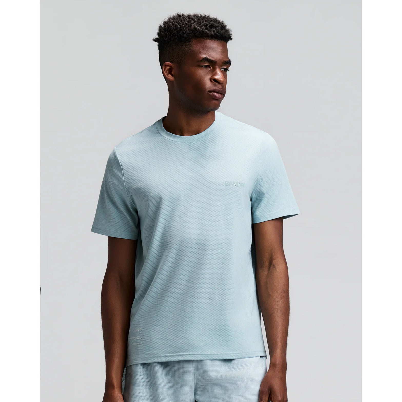 Men's Bandit Micromesh Run Tee Lagoon front view on male runner showing comfortable fit with crew neckline and breathable Micromesh construction for running and training