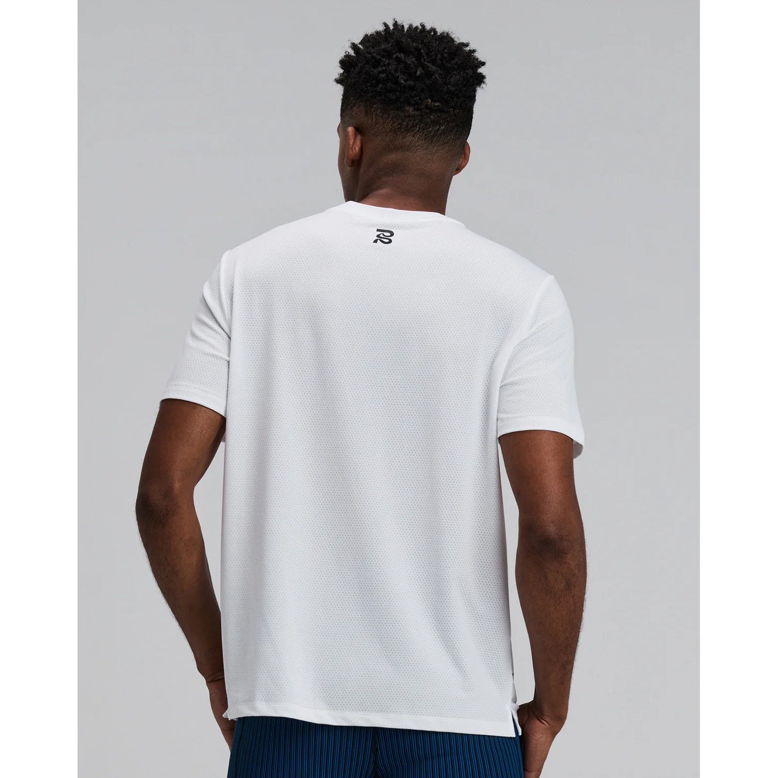 Bandit Micromesh Run Tee men's in White — back view worn on model showing relaxed fit, Micromesh™ breathable fabric construction and dyed-to-match reflective graphic at centre back
