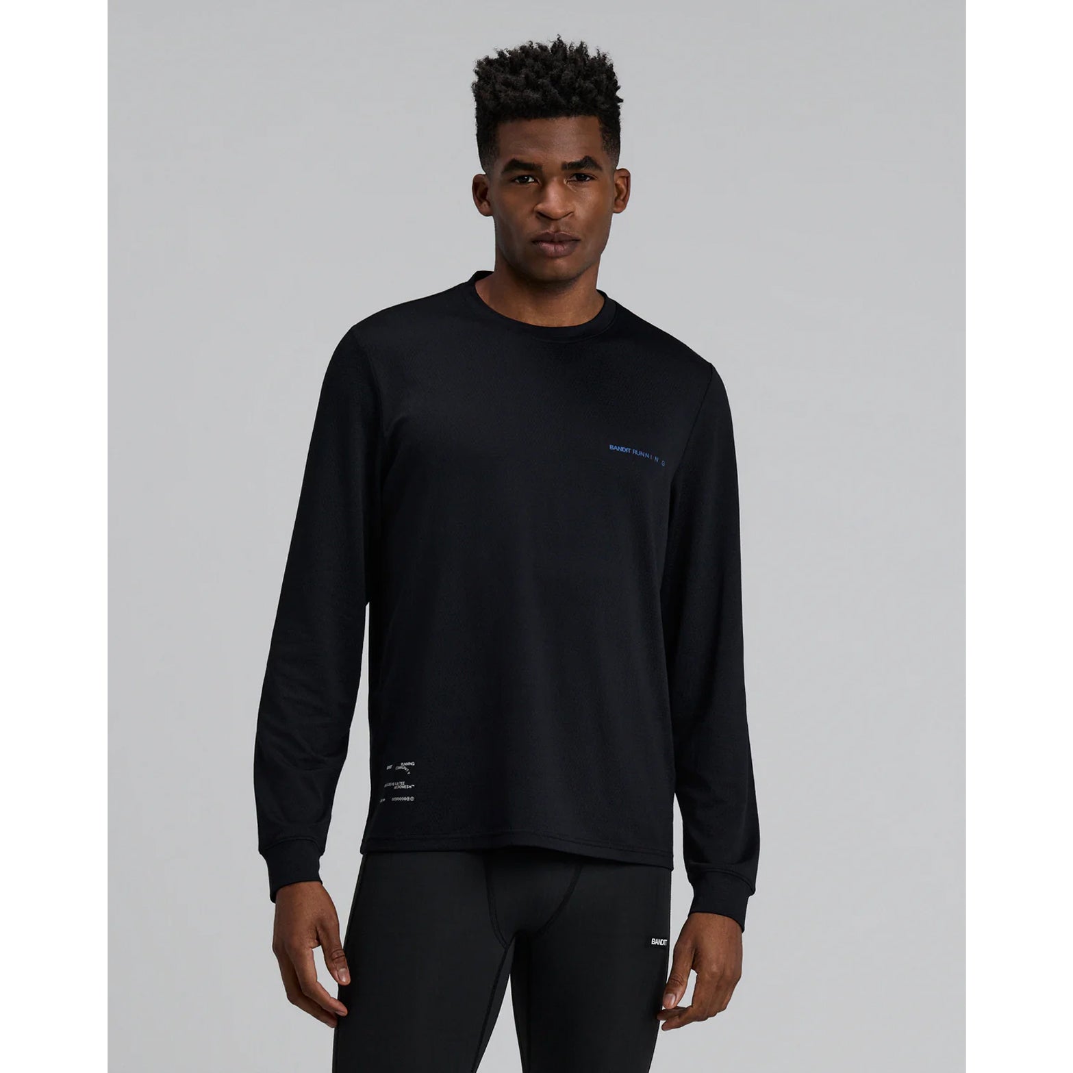 Men's Bandit Micromesh Run Top Black front view showing relaxed silhouette with sweat-wicking Oeko-Tex Certified mesh and dyed-to-match reflective graphic