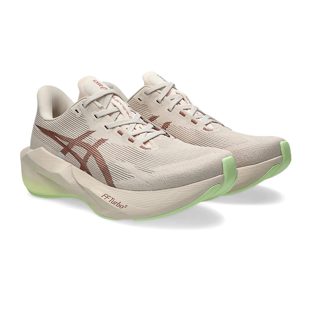 Beige running shoes with brown Asics logos, thick white soles, and light green accents on the toe and heel, positioned side by side on a white background.