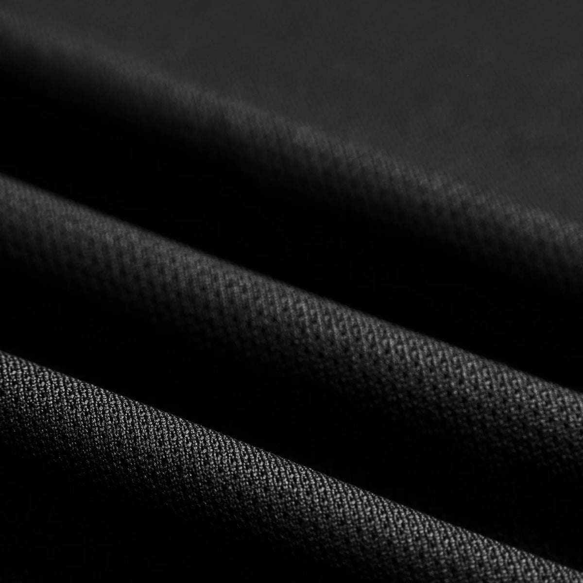District Vision Men's Paneled Training Singlet Black close-up of breathable panel construction showing moisture-wicking fabric with lightweight ventilation design for training and racing