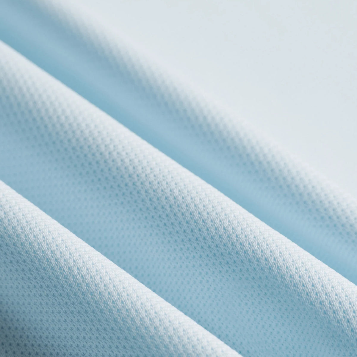 District Vision Men's Paneled Training Singlet Frost close-up of 139gsm Japanese-milled 100% polyester fabric showing featherweight mesh panel for ultralight feel with moisture management and odour control during racing and tempo runs