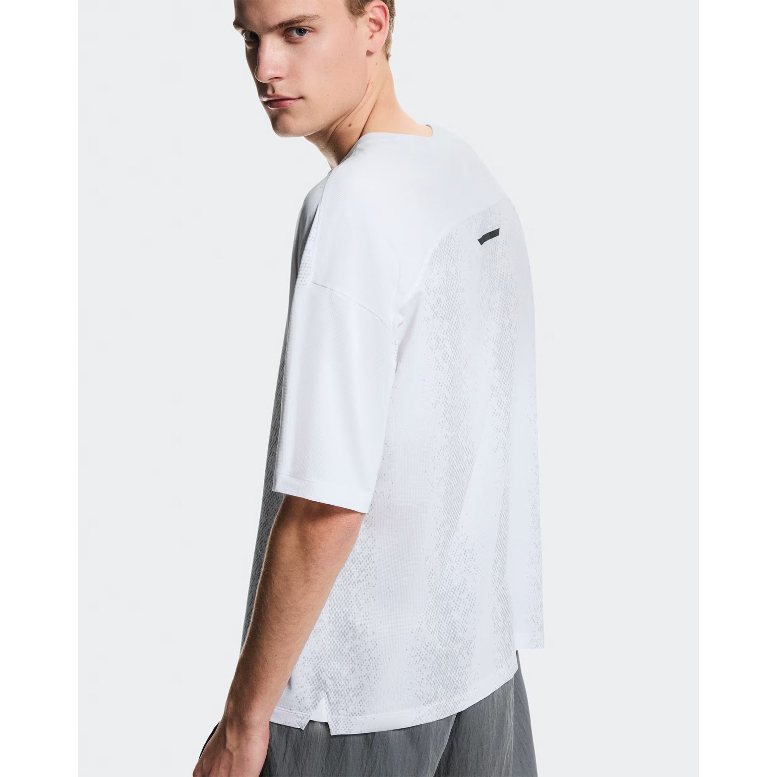 Men's On Performance Volt-T White back view on male runner showing relaxed fit with On DryTec technology for versatile training and recovery wear