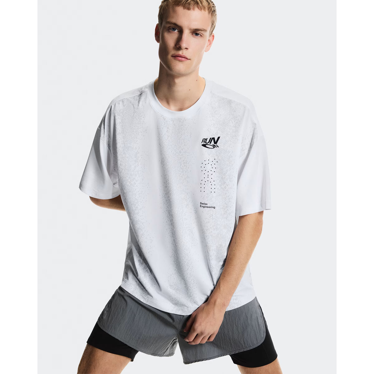 Men's On Performance Volt-T White close-up front showing expressive run-culture graphics with typographic elements and quick-drying fabric construction