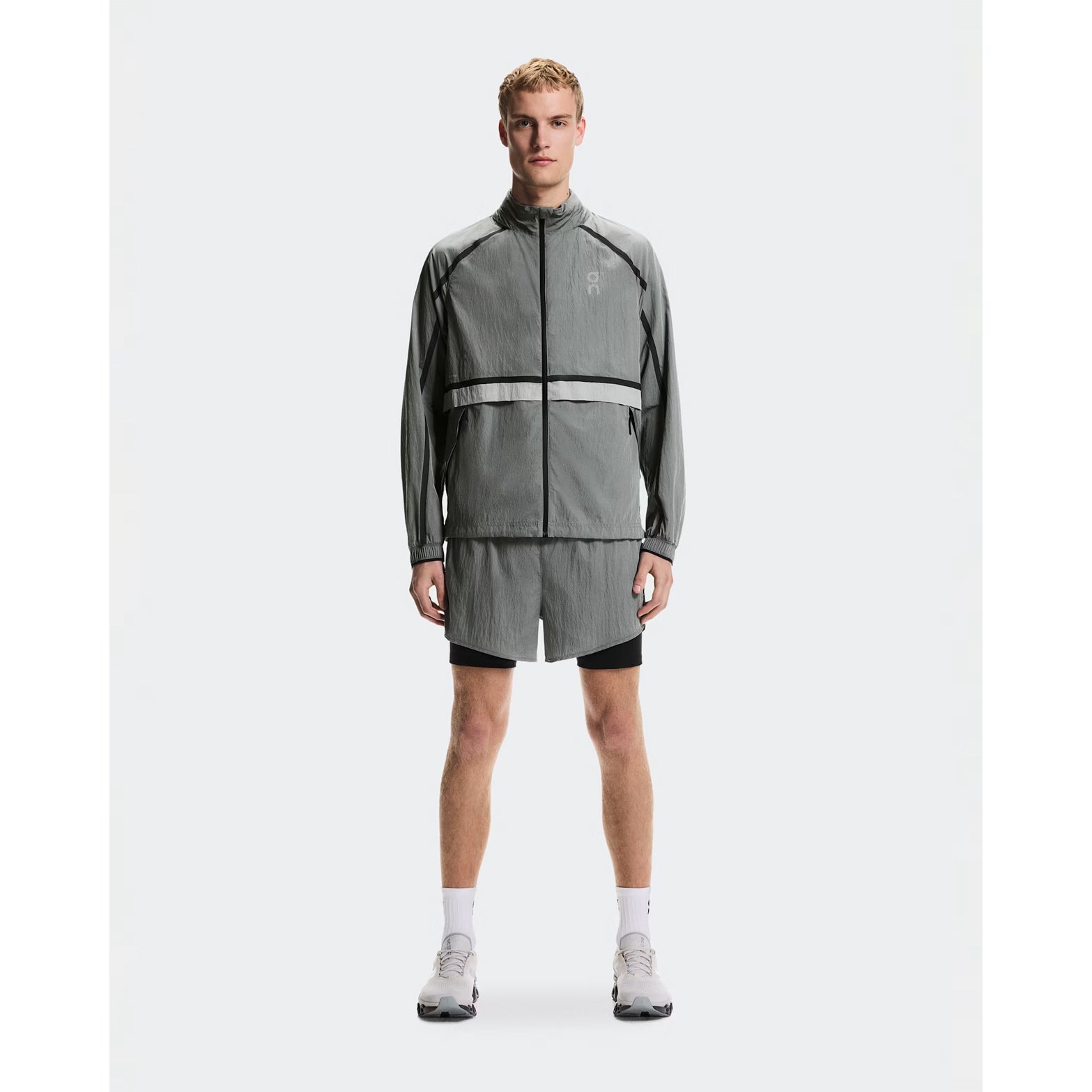 Men's On Performance Volt Shorts Glacier full body front view on male runner showing dual-layer design with windproof outer and moisture-wicking inner for everyday training