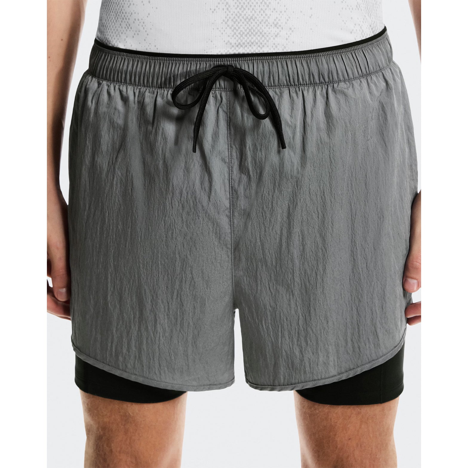 Men's On Performance Volt Shorts Glacier close-up front showing iridescent fabric outer with inner pockets and four-way stretch supportive tights