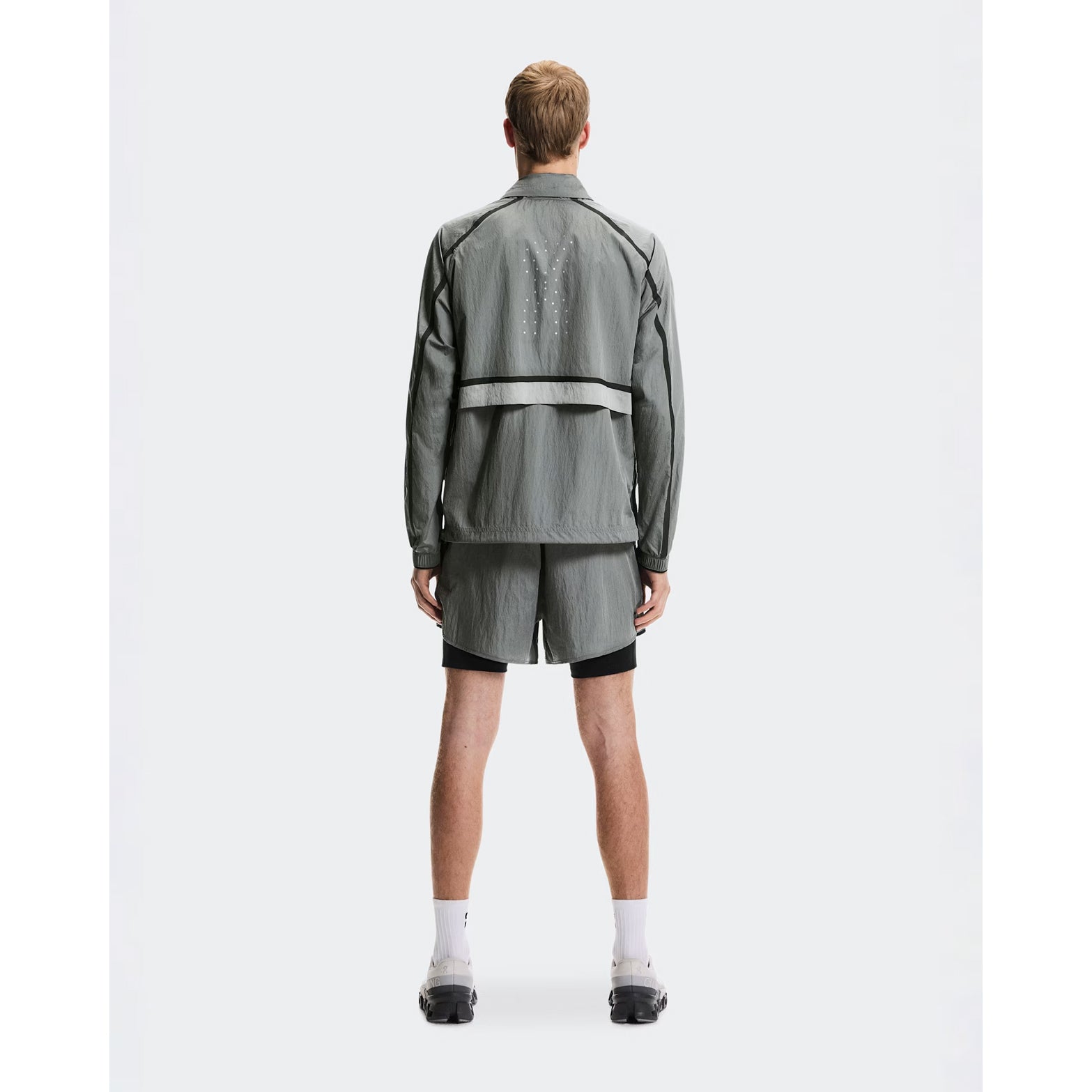 Men's On Performance Volt Shorts Glacier full body back view on male runner showing additional back pocket storage and water-repellent iridescent outer layer