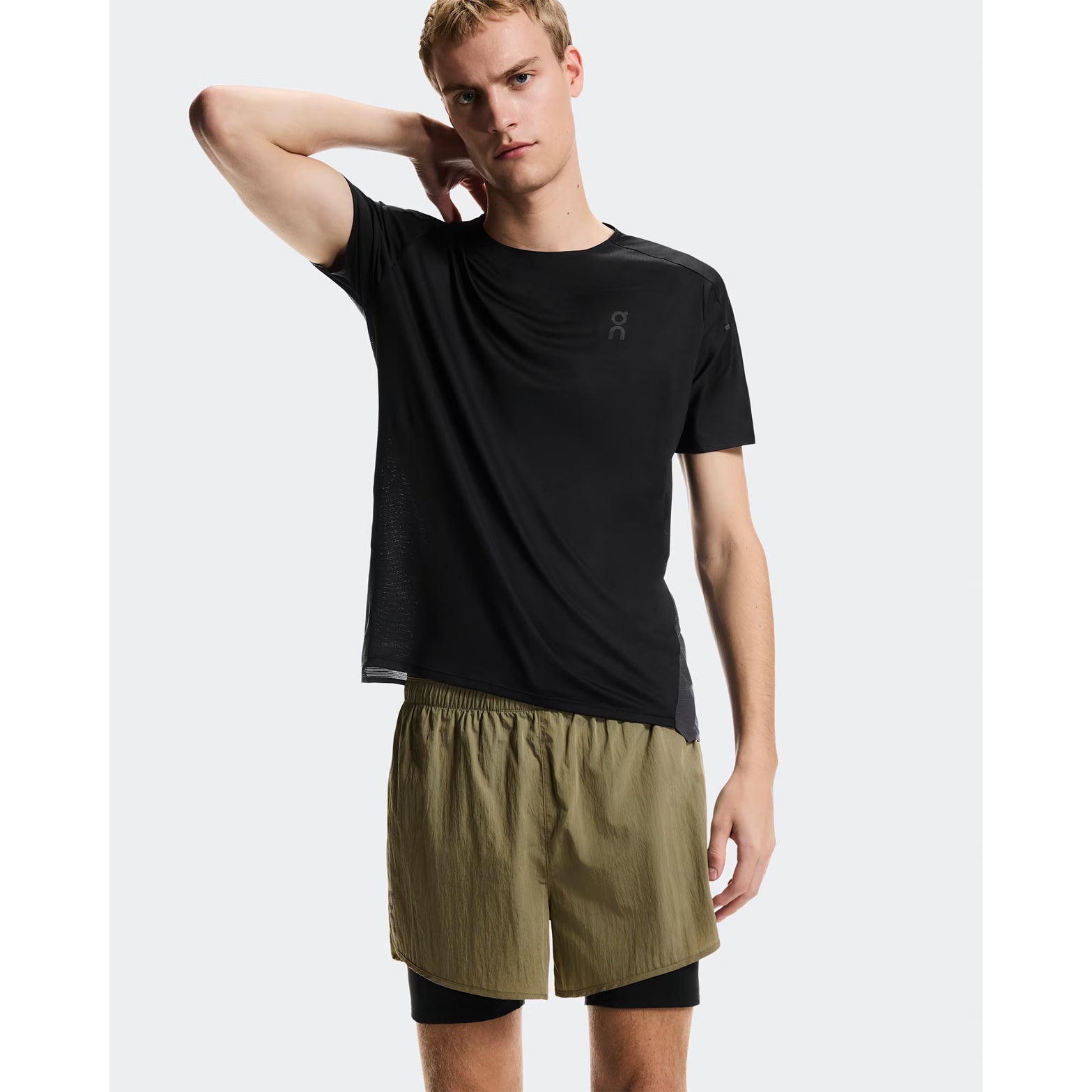 Men's On Performance Volt Shorts Safari front view on male runner showing lightweight iridescent outer fabric with moisture-wicking On DryTec inner layer