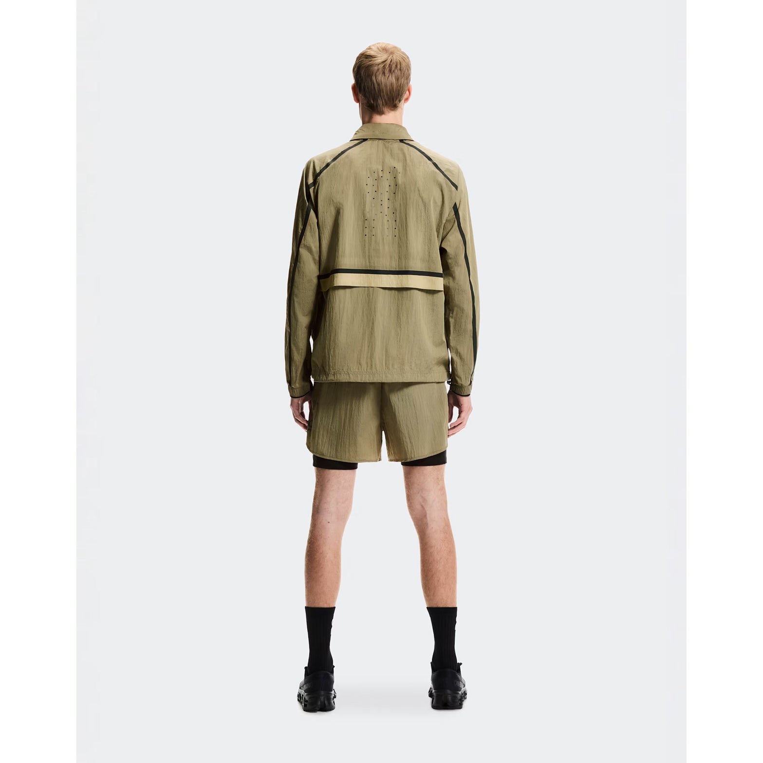 Men's On Performance Volt Shorts Safari full body front view on male runner showing dual-layer design with windproof outer and moisture-wicking inner for everyday training