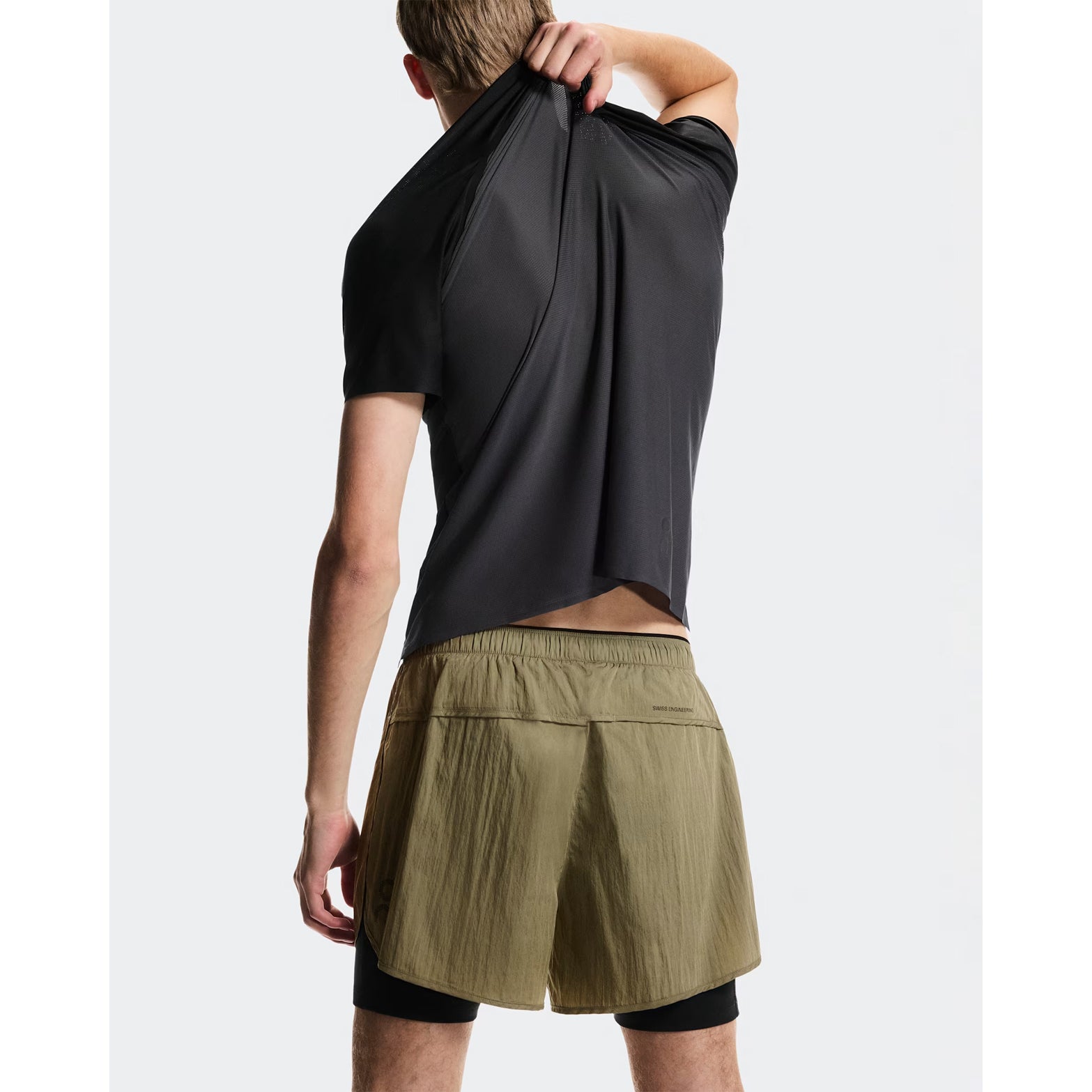Men's On Performance Volt Shorts Safari back view on male runner showing additional back pocket for storage and windproof water-repellent outer construction